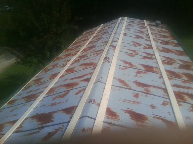 Rusted metal roof panels with new wood purlins before replacement — Storm Damage Roof Repair in Beryl by Roofing Brothers
