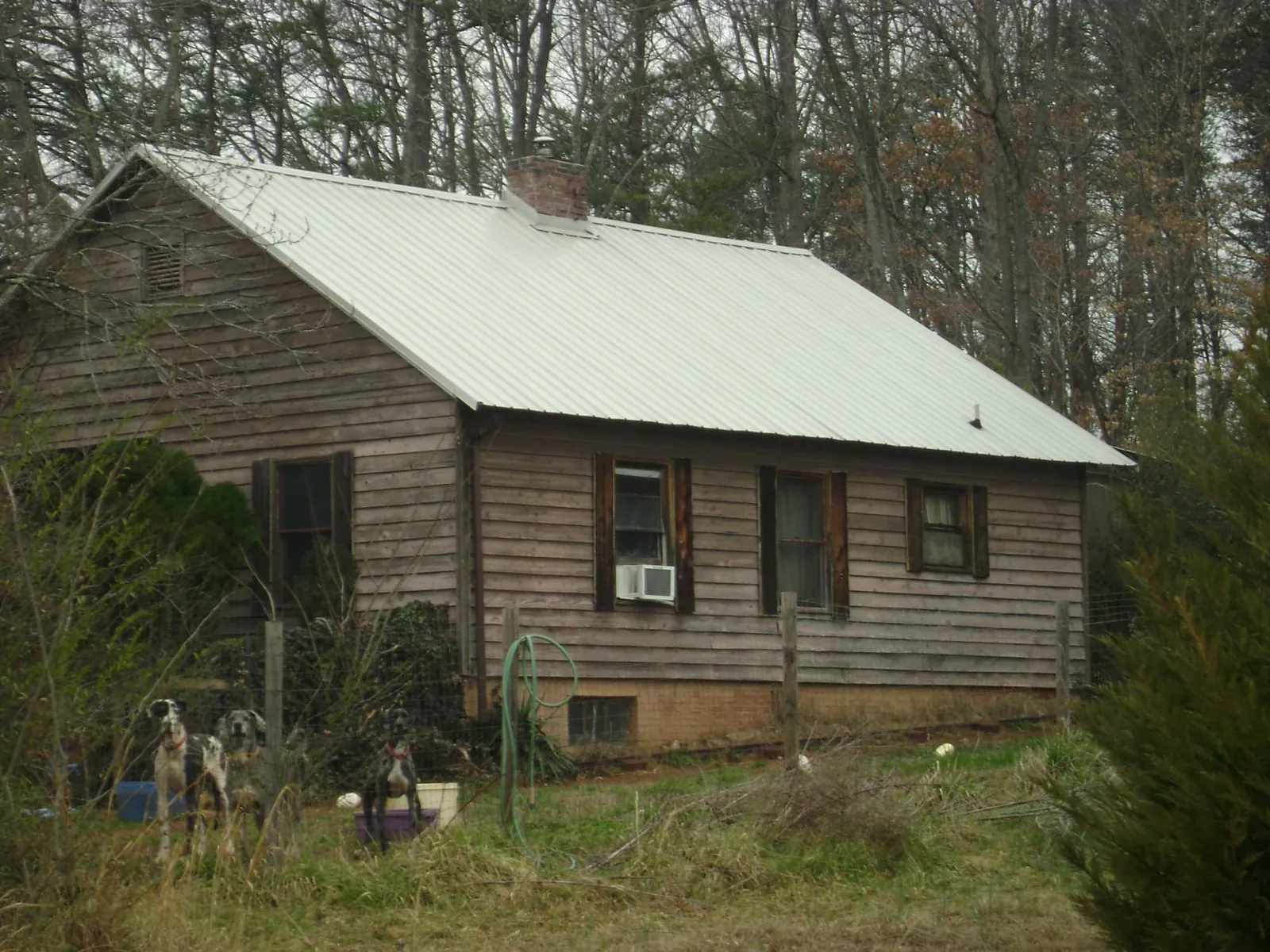 White metal roof on an old wood sided farmhouse, from a Metal Roof Installation job in Beryl